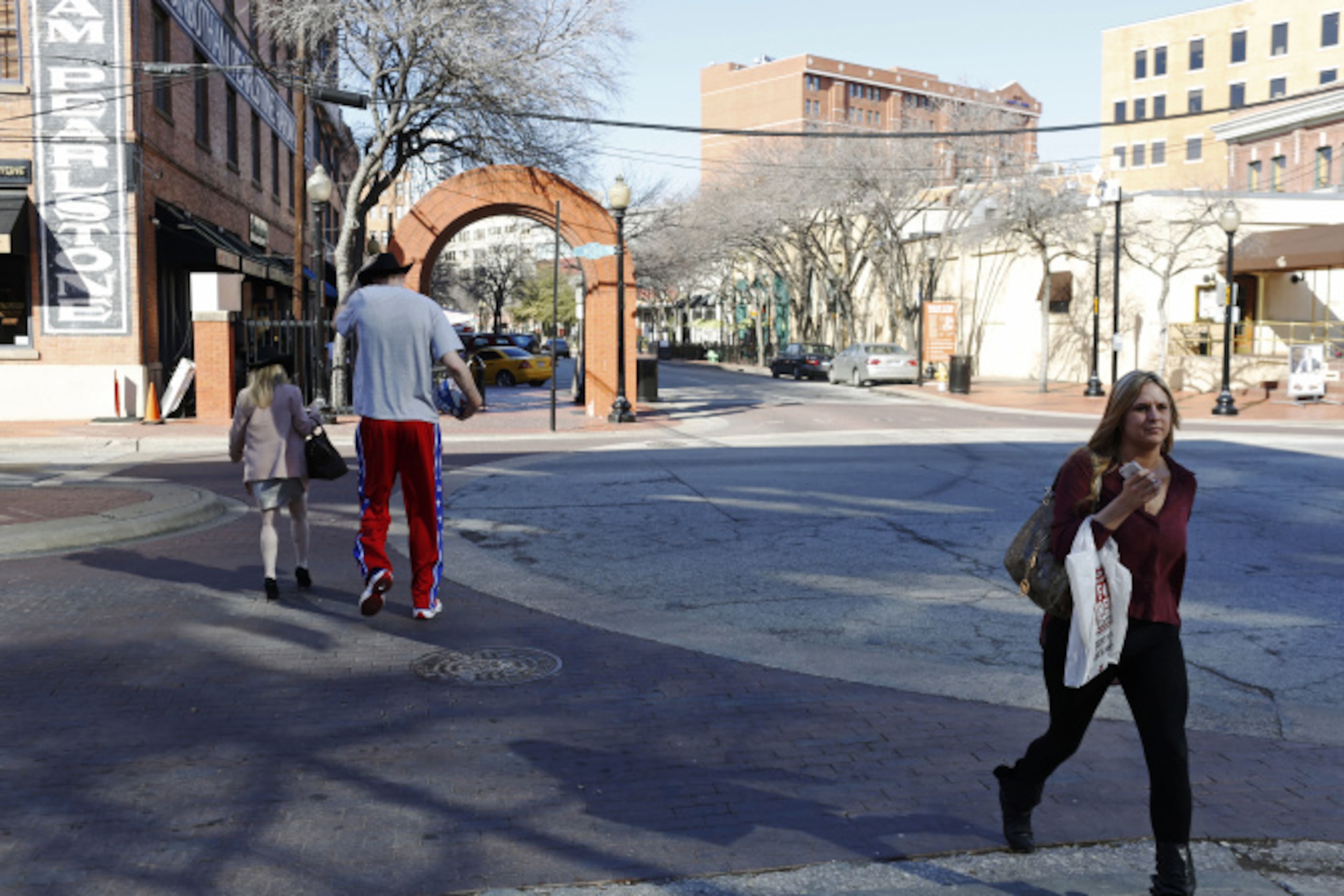 Harlem Globetrotter Paul "Tiny" Sturgess walks down North Market Street after getting sized...