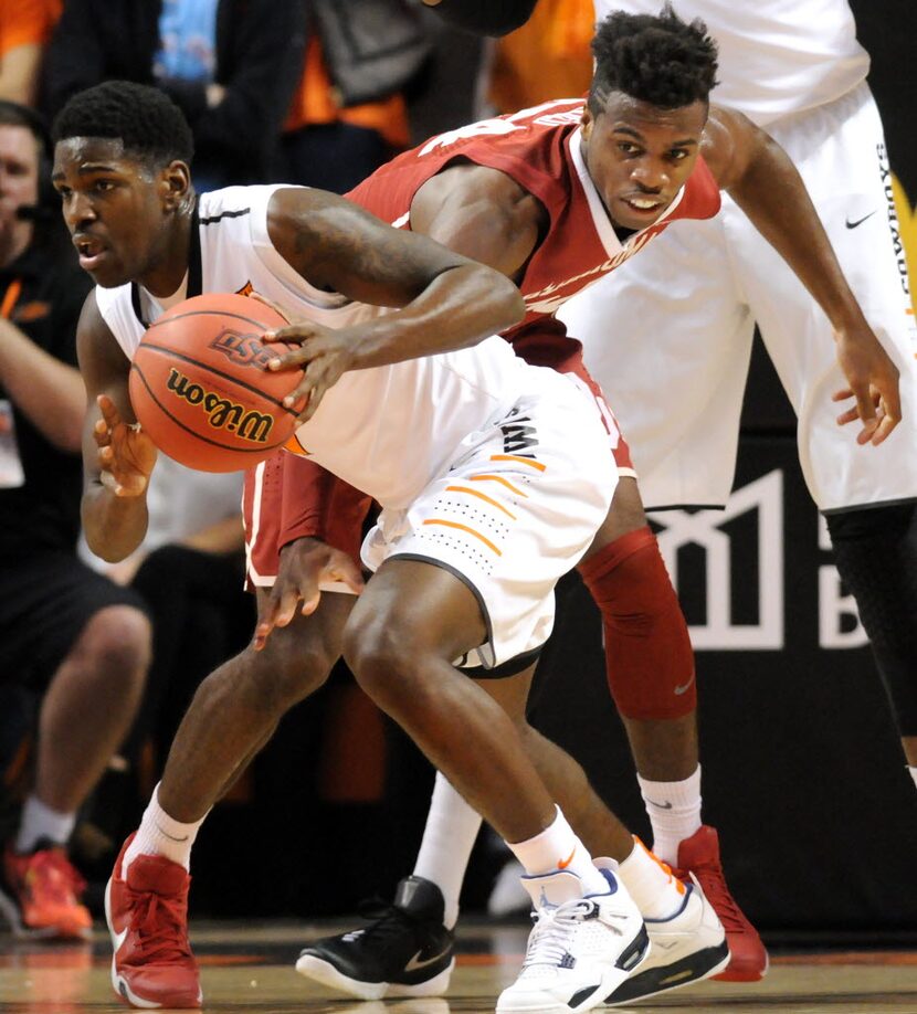 Oklahoma State Jawun Evans, left, steals the basketball from Oklahoma guard Davon Dillard...