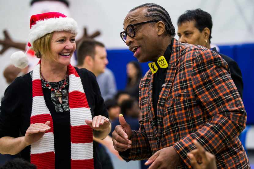 Volunteer Susan O'Neal talks with commissioner John Wiley Price as juvenile inmates receive...