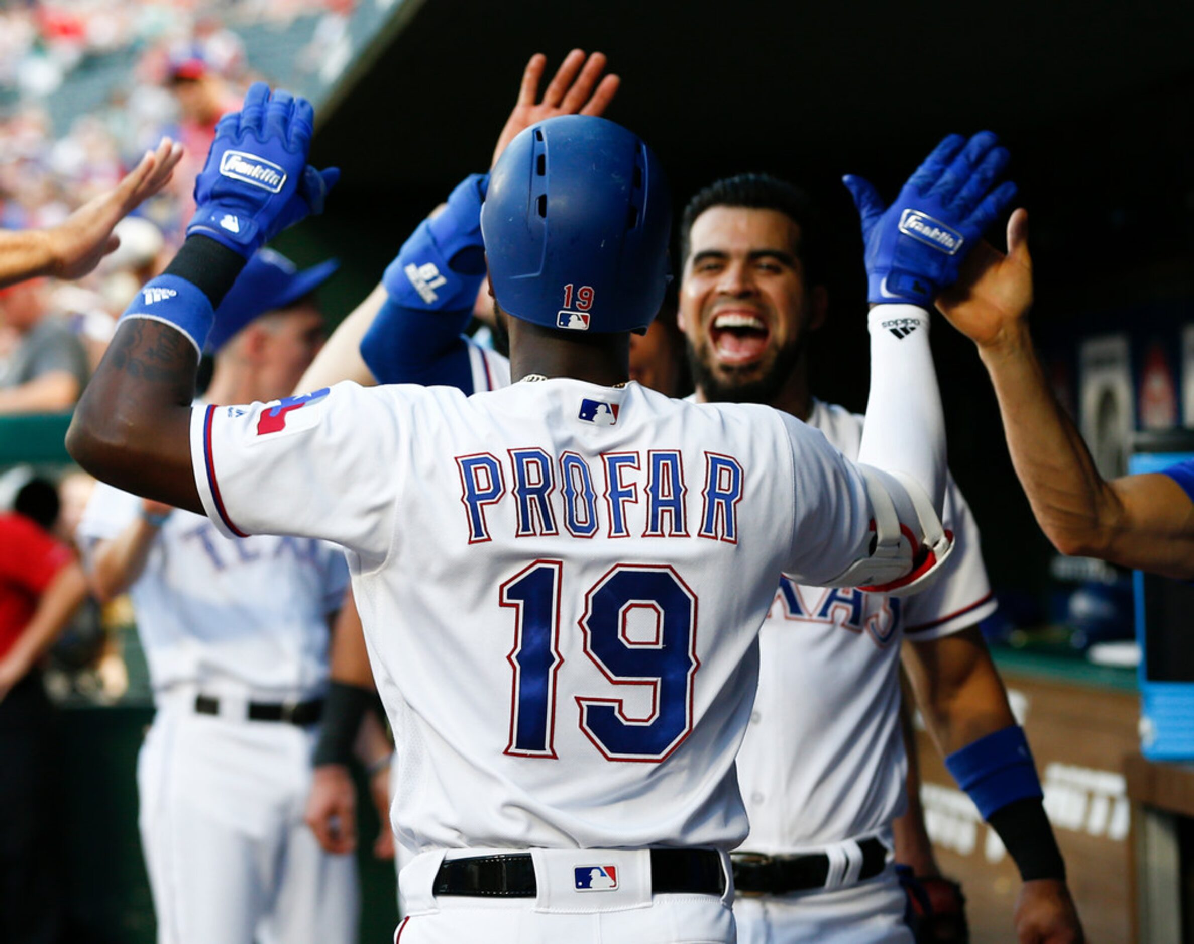 Texas Rangers' Jurickson Profar (19) celebrates his home run as he arrives to the dugout...