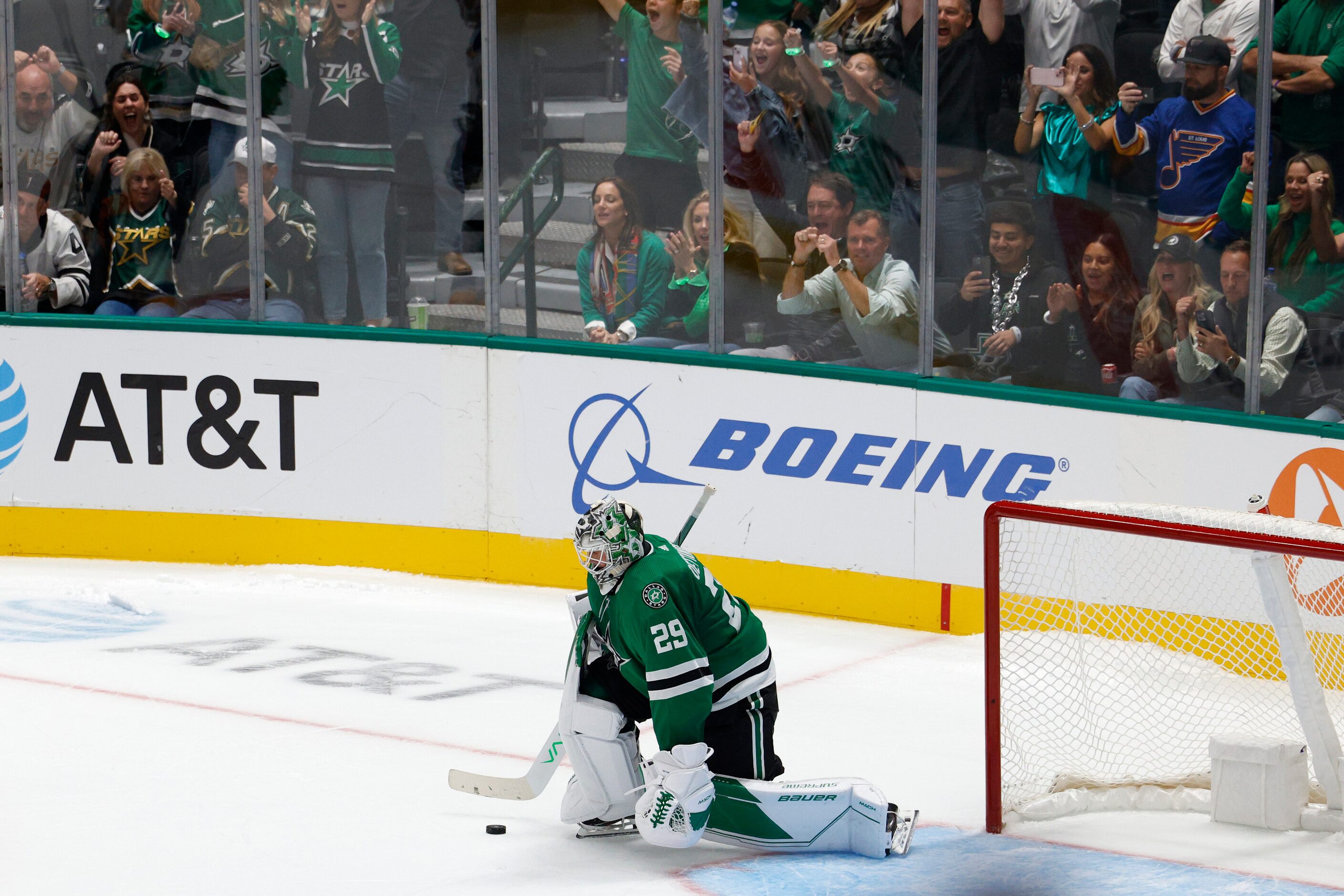 Fans celebrate as Dallas Stars goaltender Jake Oettinger (29) stops a shot during a shootout...