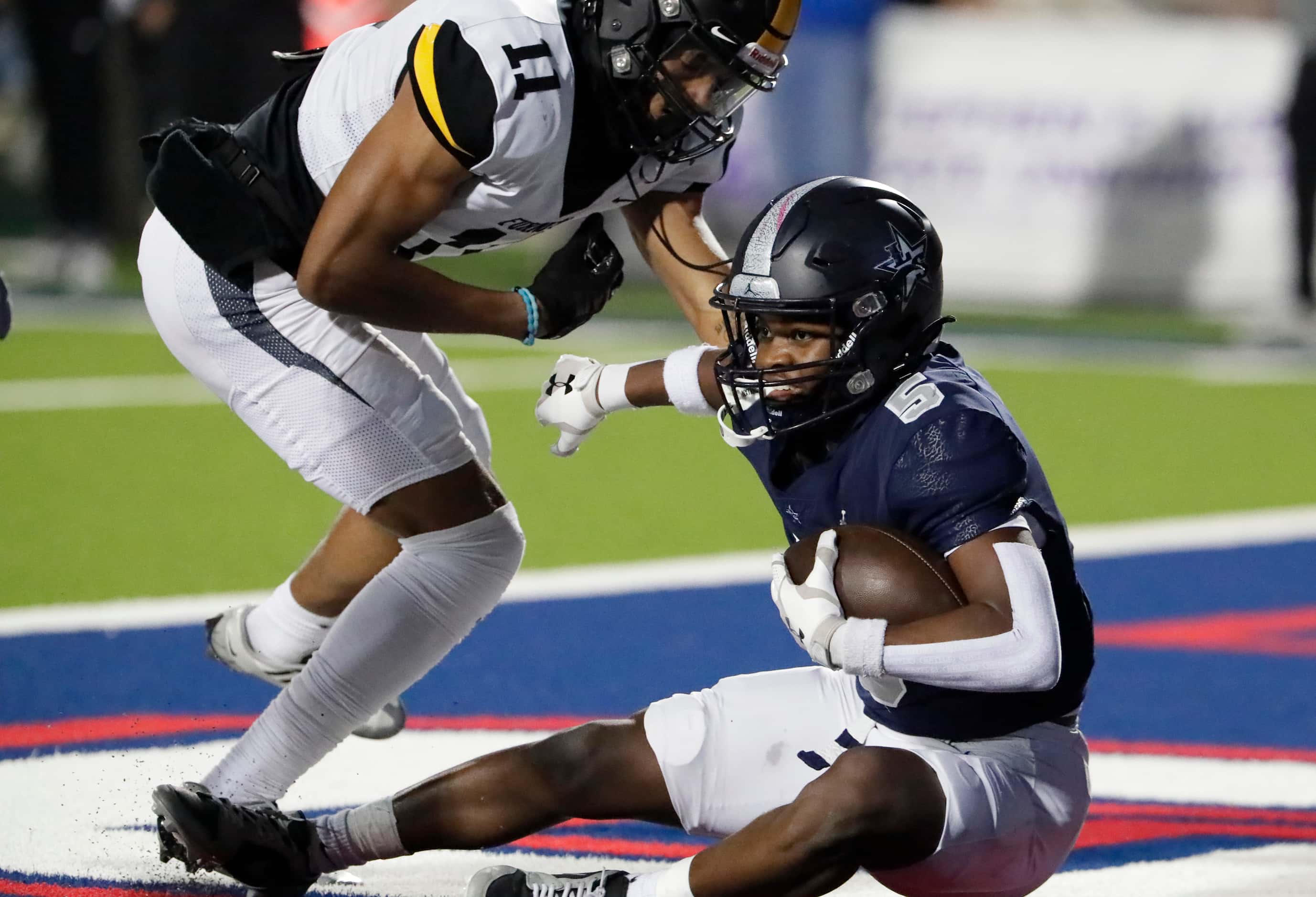 Lone Star High School cornerback Silas Davis (5) comes down with an interception in the end...