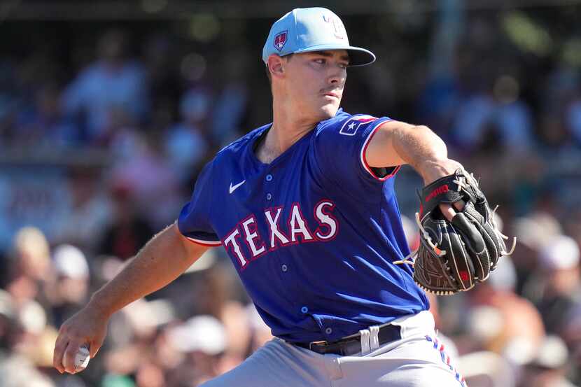 Texas Rangers pitcher Cole Winn delivers during the fourth inning of a spring training game...