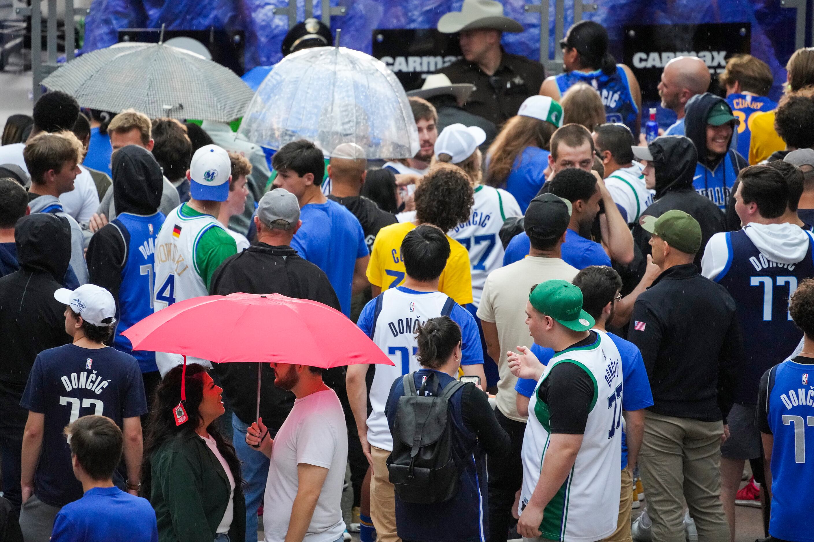 Fans wait in a light rain on the plaza before Game 4 of the NBA Western Conference Finals...