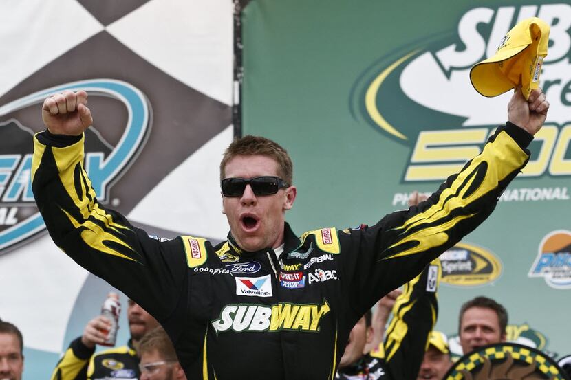 Carl Edwards celebrates after winning the NASCAR Sprint Cup Series auto race, Sunday, March...