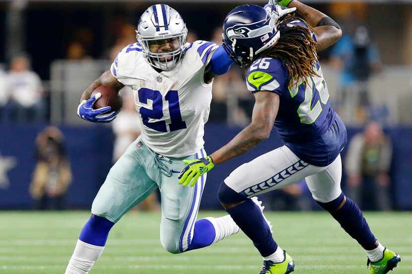 Dallas Cowboys running back Ezekiel Elliott (21) takes down Seattle Seahawks cornerback...