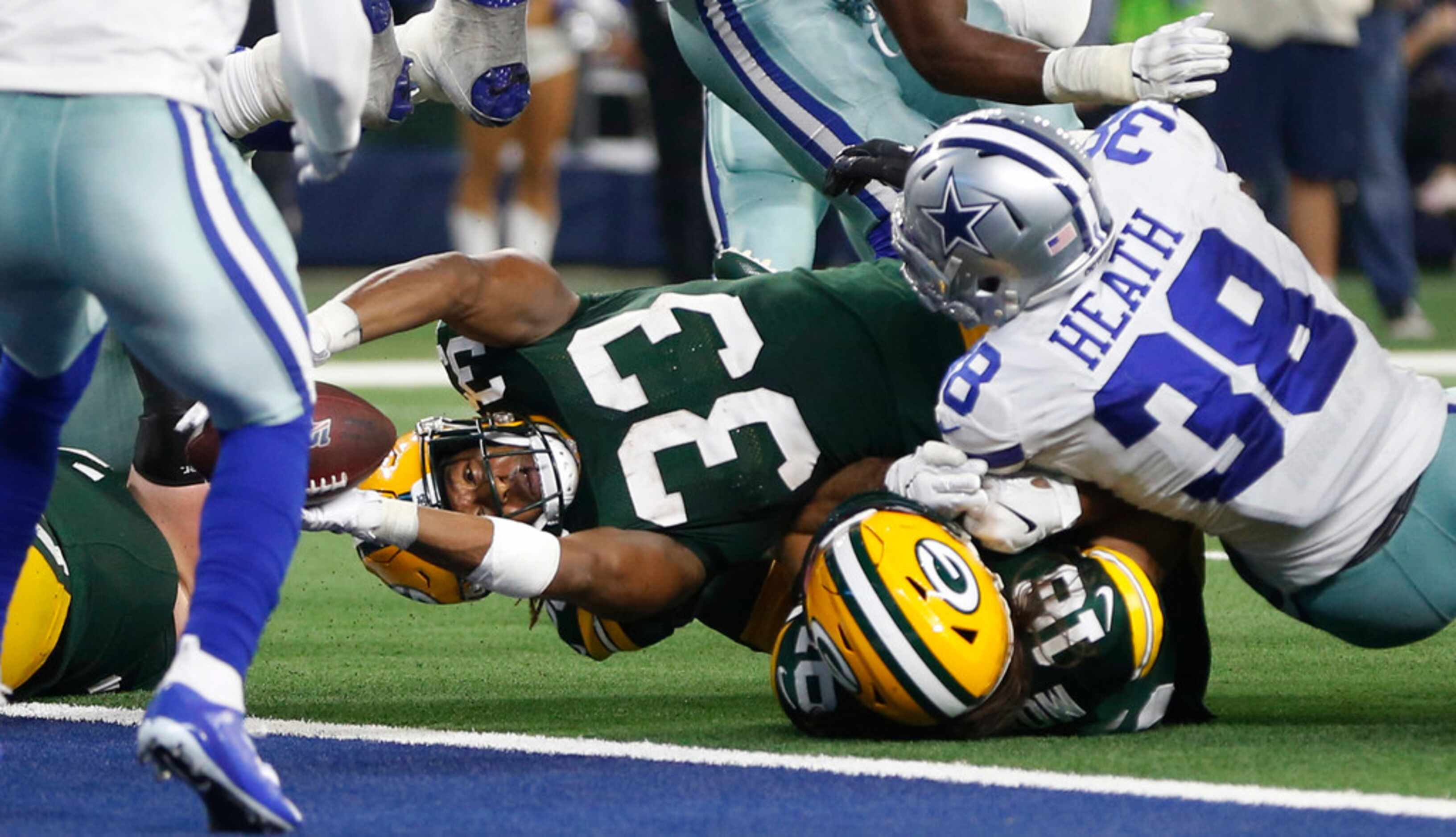 Green Bay Packers running back Aaron Jones (33) dives for the touchdown as Dallas Cowboys...