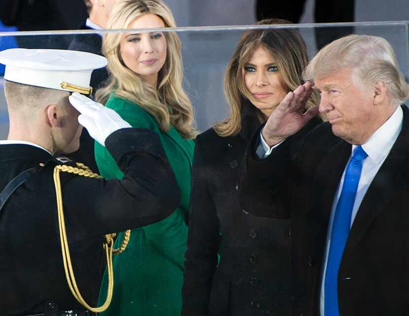 President-elect Donald Trump salutes as his wife Melania and daughter Ivanka Trump look on...