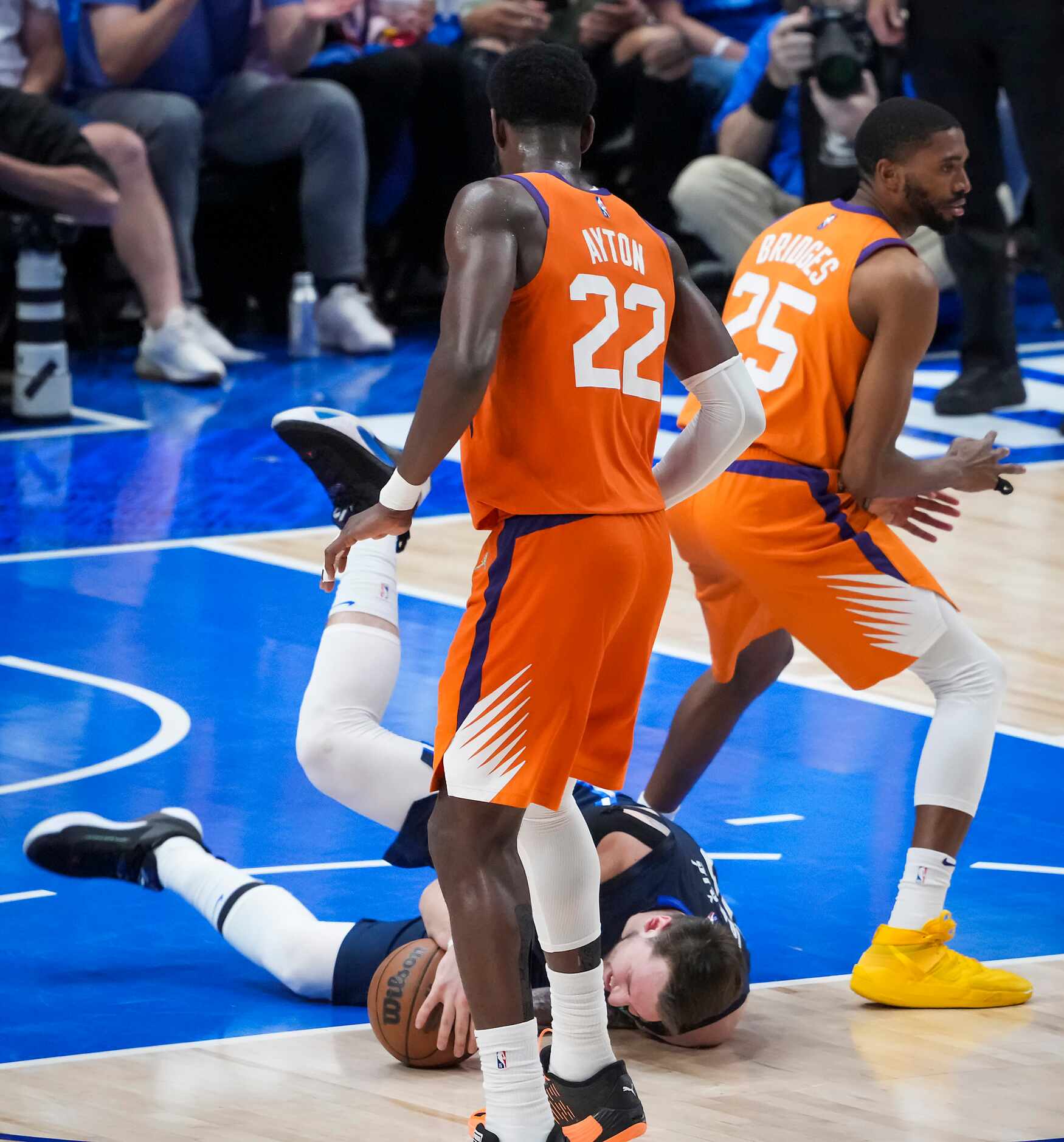 Dallas Mavericks center Dwight Powell (7) falls to the court after being fouled by Phoenix...