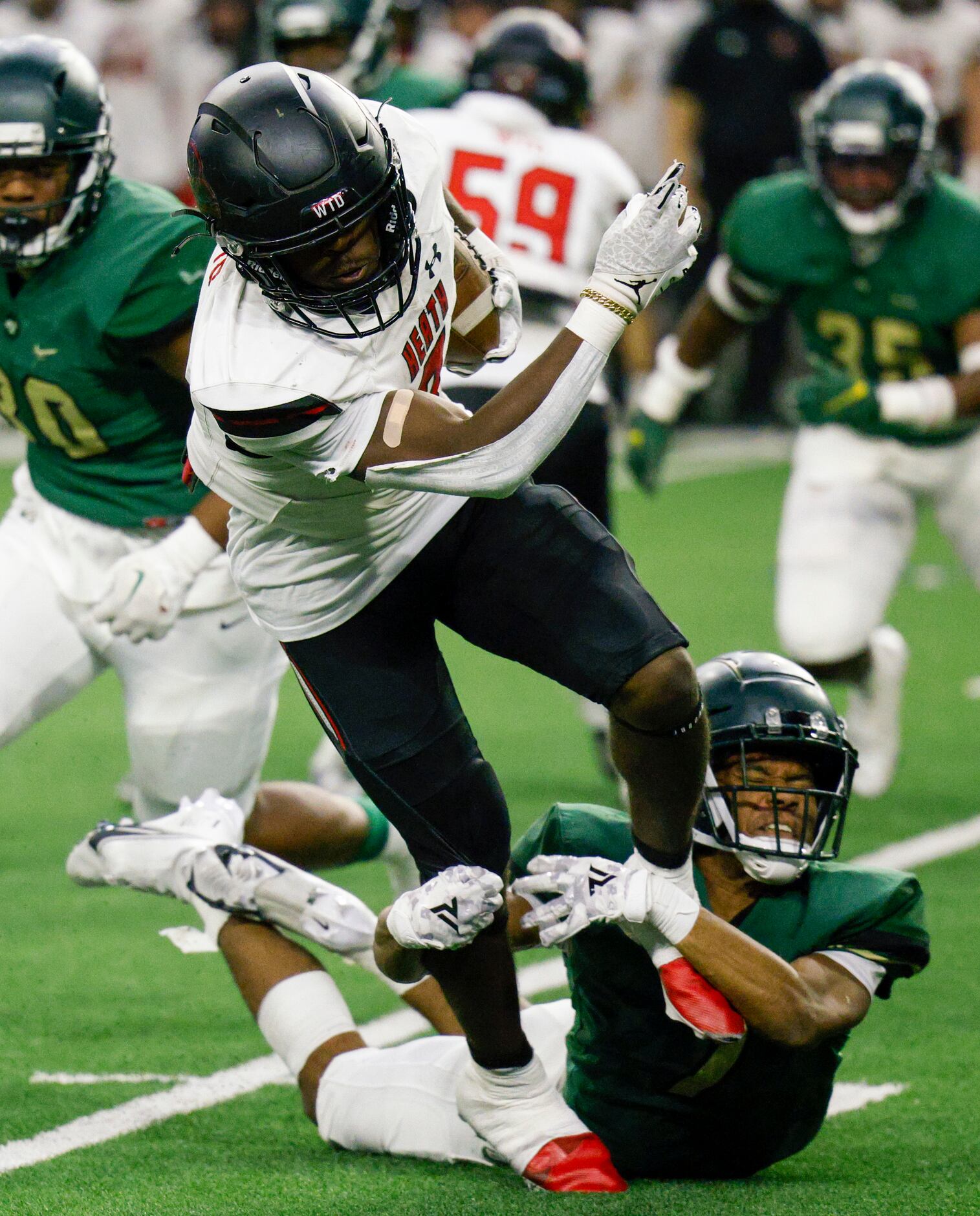 DeSoto’s Jamarion Ravenell (7) tackles Rockwall-Heath’s Malachi Tuesno (0) during the first...