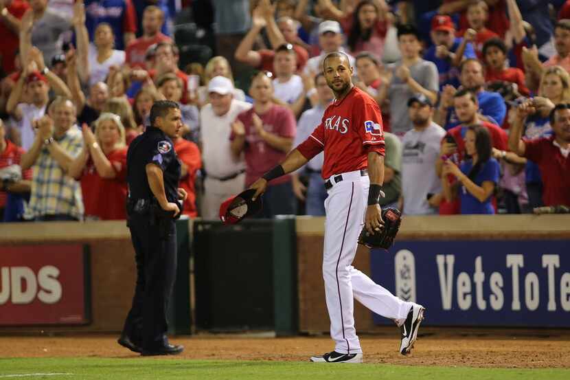 ARLINGTON, TX - SEPTEMBER 23: Alex Rios #51 of the Texas Rangers waves his cap after hitting...