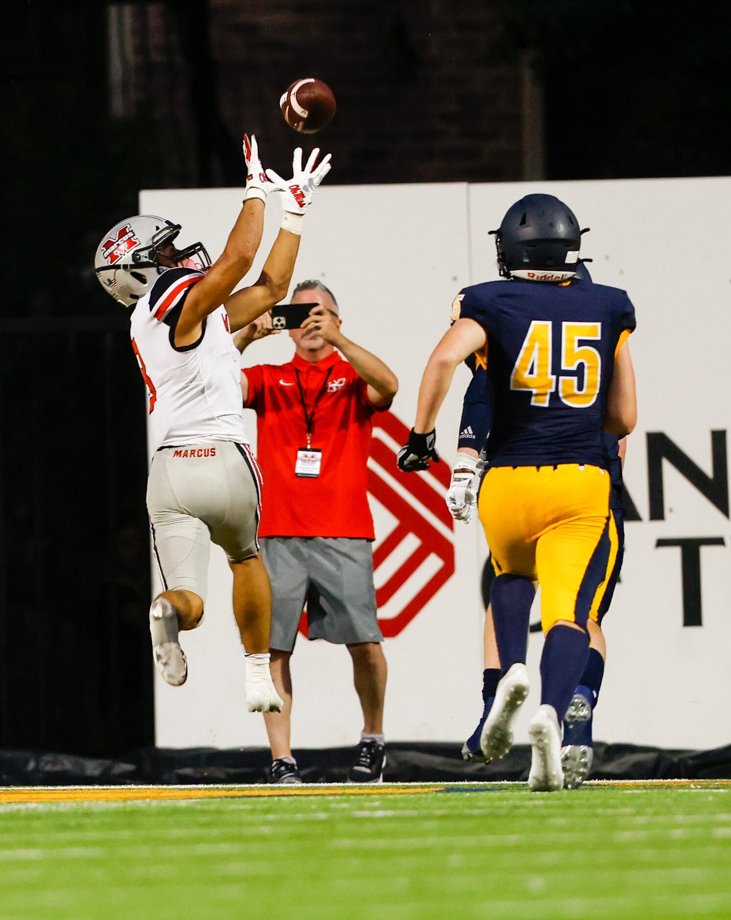 Flower Mound Marcus’s Chance Sautter (3) catches a touchdown pass against Highland Park...