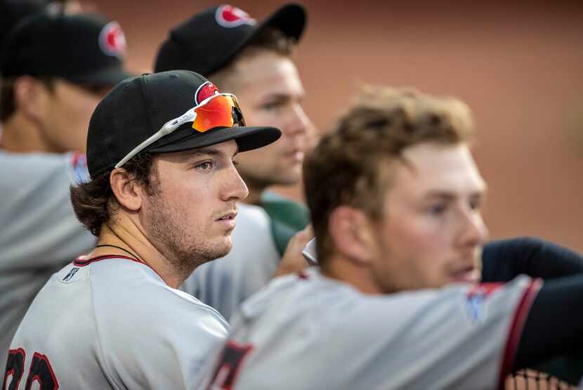Hickory Crawdad's Trevor Hauver (33) watches the game with the Greensboro Grasshoppers from...