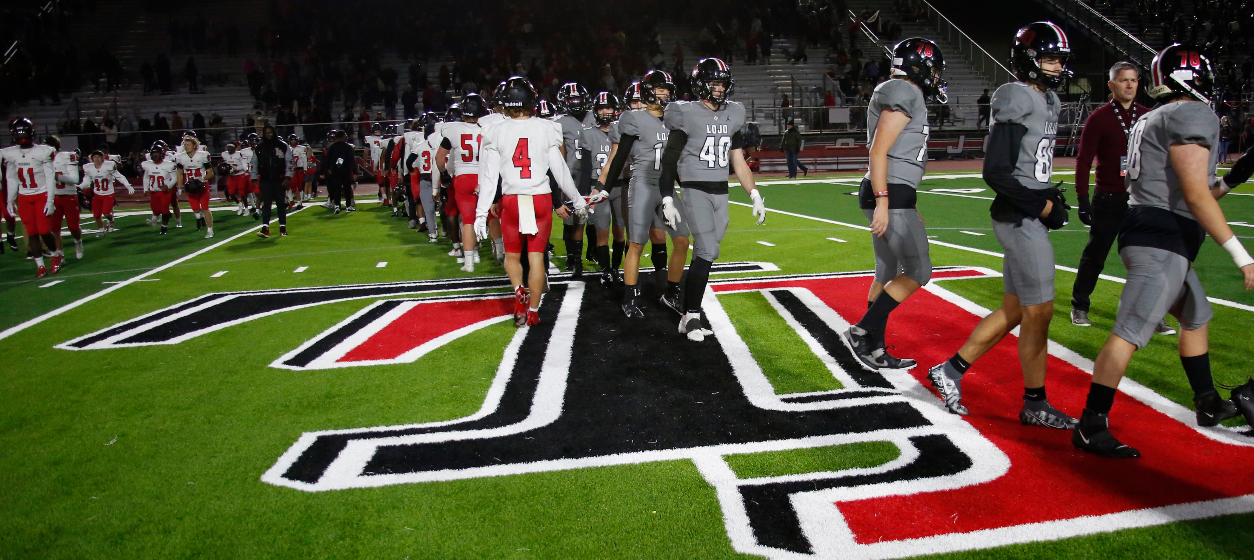 Players from the Lucas Lovejoy team, right, shake hands with members of the Frisco Liberty...