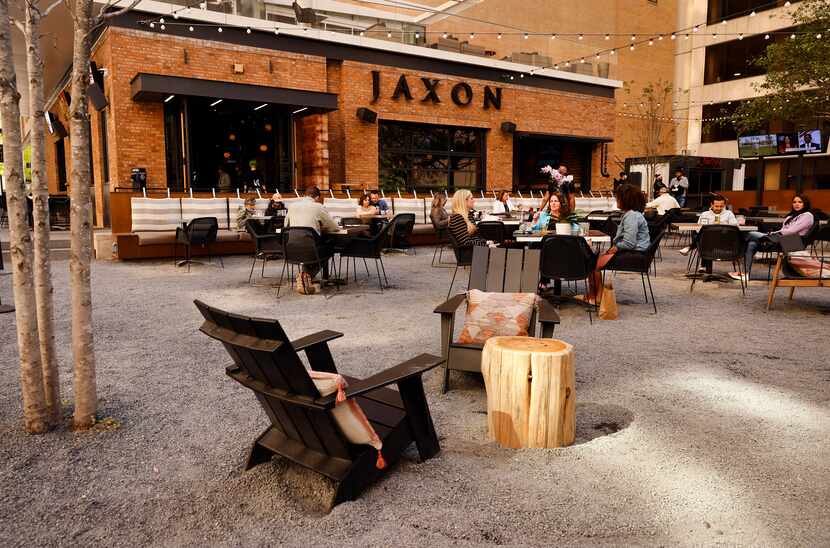 Visitors gather at the indoor and outdoor dining and entertainment area in the new AT&T...