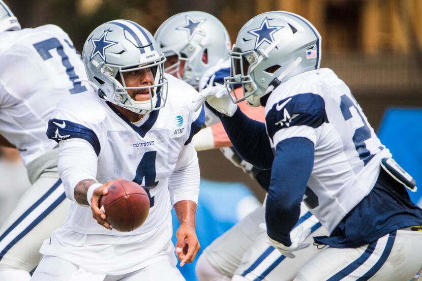 Dallas Cowboys quarterback Dak Prescott (4) hands off to running back Darius Jackson (26)...
