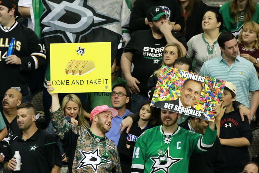 Dallas Stars fans display their signs during an officials review of Antoine Roussel's second...