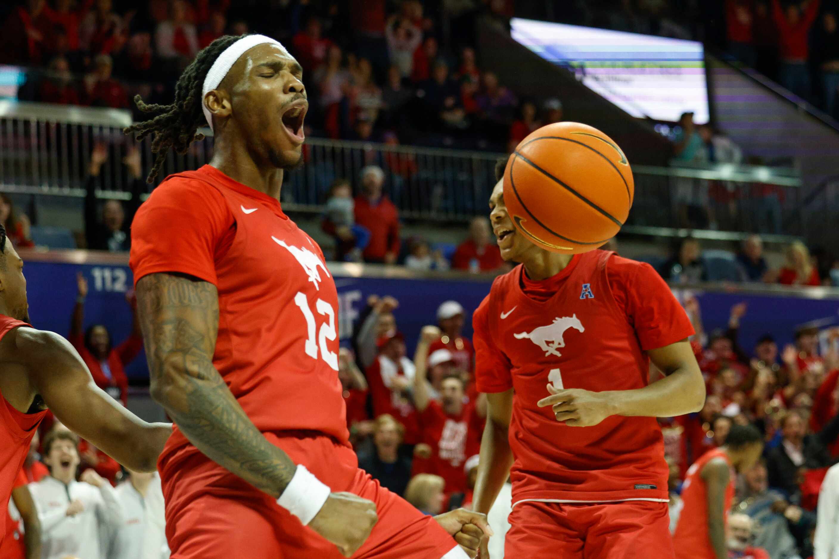SMU forward Tyreek Smith (12) reacts after a dunk during the second half of an NCAA...
