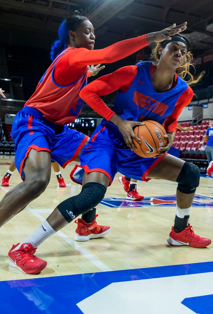 Southern Methodist University forward Alexis Leggett (right, 5) pivots away from forward...