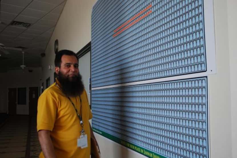 
East Plano Islamic Center board president Muhammad Jawaid Isa stands in front of a board...