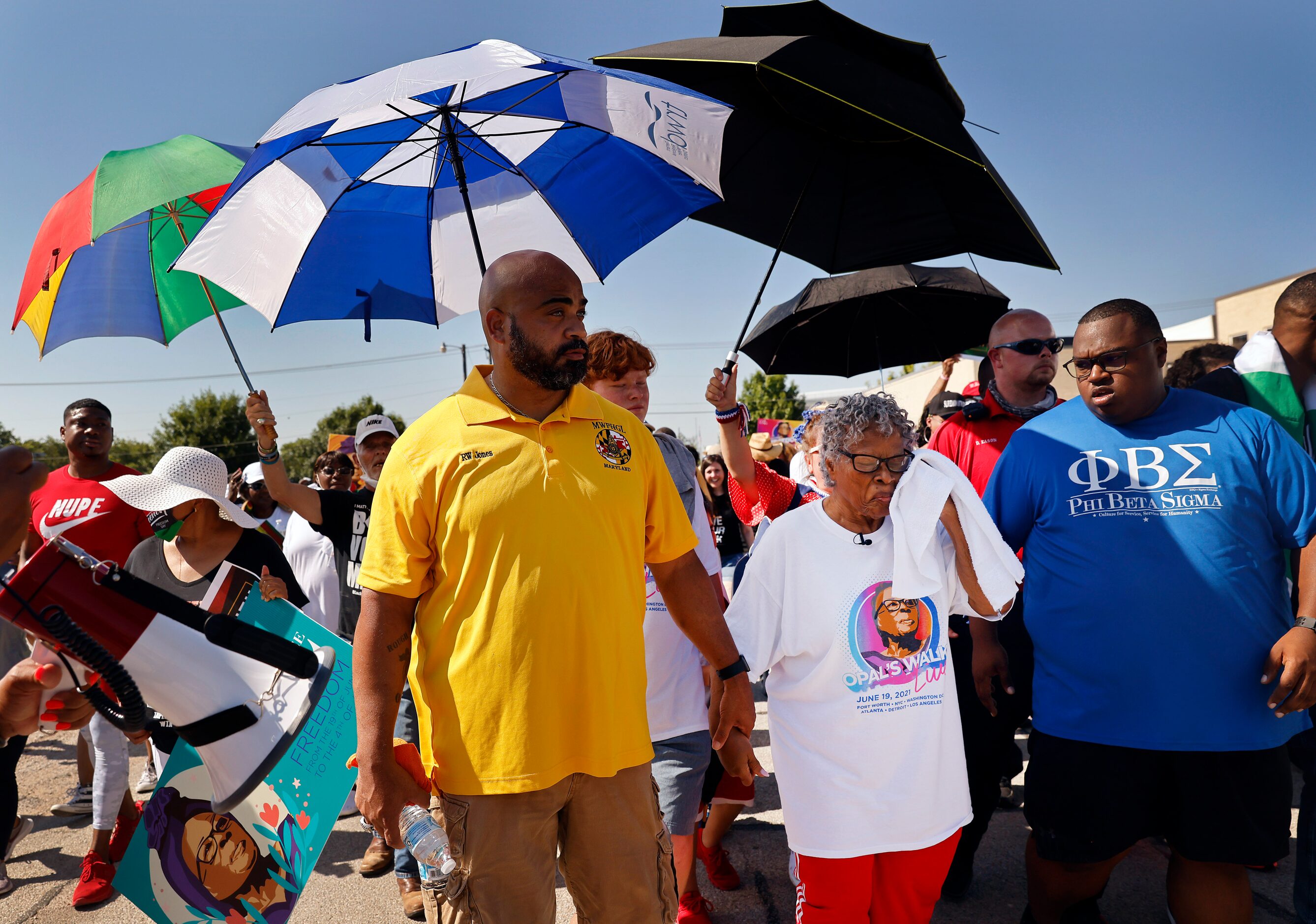 Opal Lee (second from left) had a shaded escort as she trekked down Evans Ave headed for...