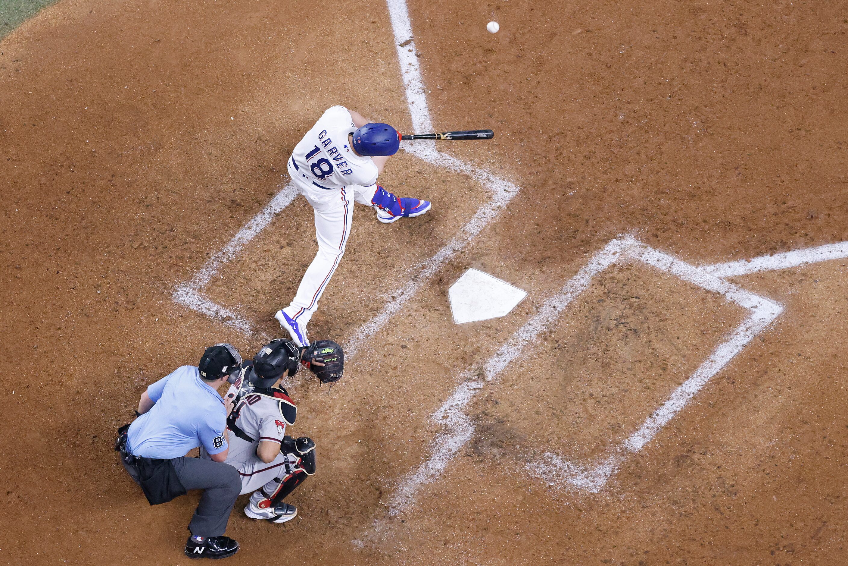 Texas Rangers designated hitter Mitch Garver hits a solo home run off Arizona Diamondbacks...