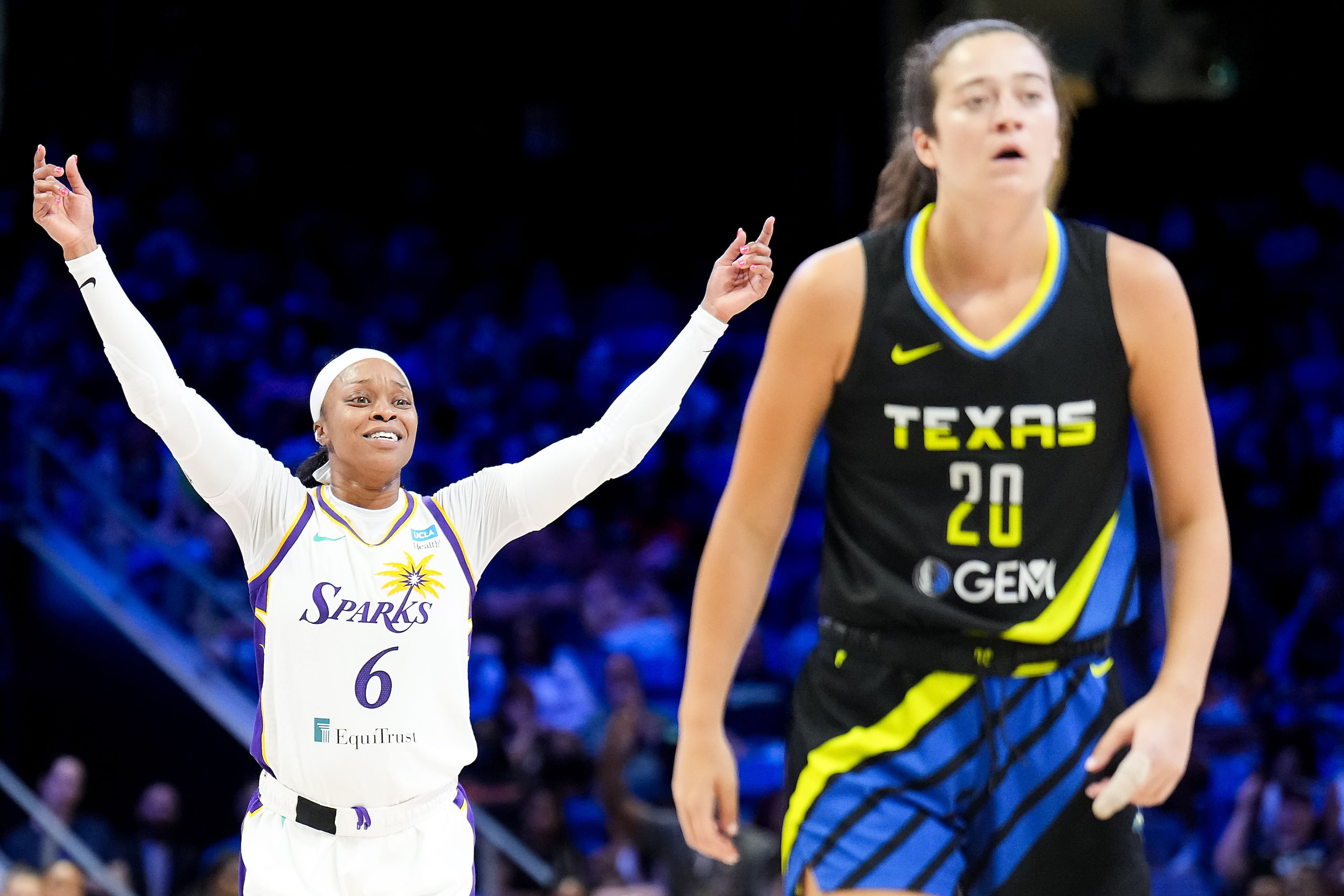 Los Angeles Sparks guard Odyssey Sims (6) celebrates a basket behind Dallas Wings forward...