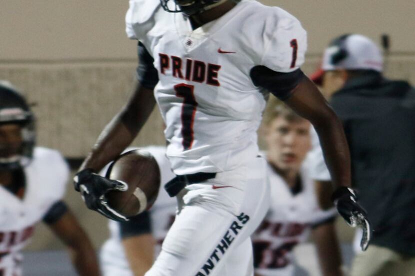 Colleyville Heritage receiver Ke'von Ahmad (1) tiptoes the sideline after pulling in a first...