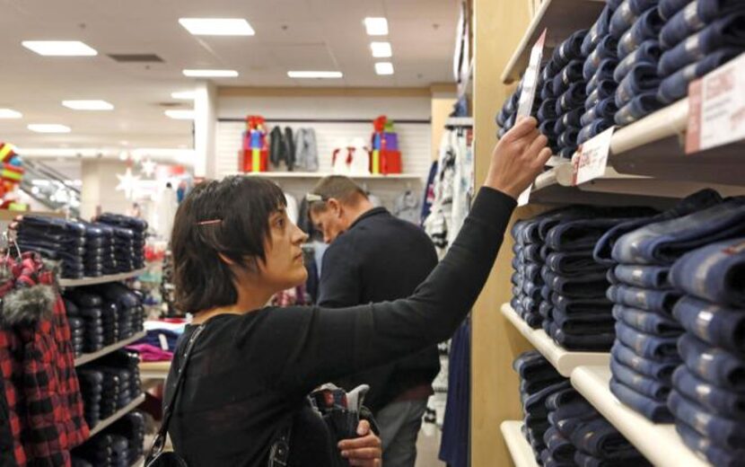 
Corey and Eric Fitzgerald check out jeans at the J.C. Penney store at Stonebriar Centre in...