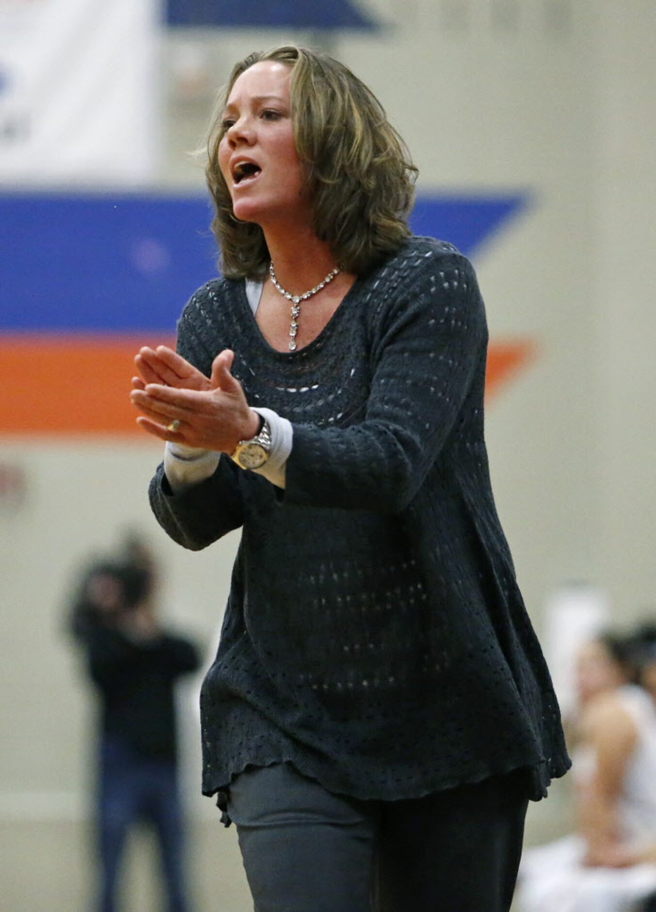 McKinney High School head coach Debbie Harris encourages her team in the second quarter...