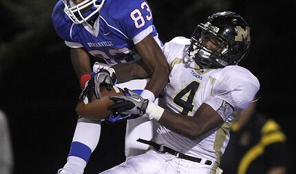 Duncanville receiver Jeff Thomas (83) wrestles the ball from Mansfield's Damon Bullock (4).