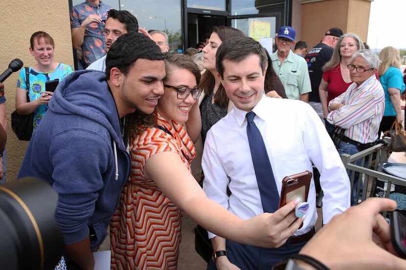 South Bend, Ind., Mayor Pete Buttigieg (right) posed for a selfie with Cameron Mitchell and...