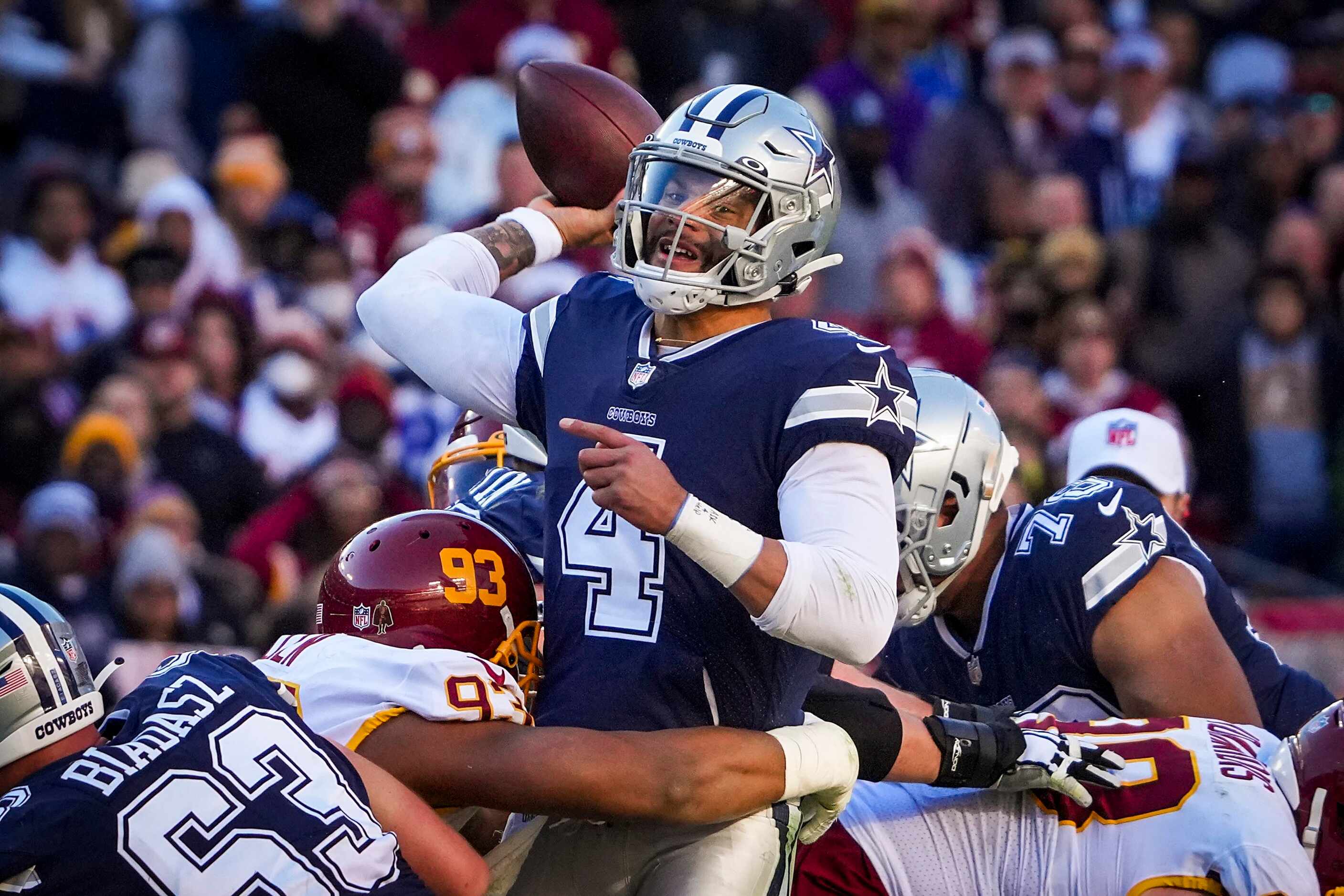 Dallas Cowboys quarterback Dak Prescott (4) throws as he is hit by Washington Football Team...