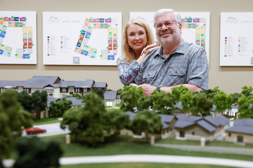 Mary Jacobs and Steve Lavine pose for a portrait in front of a 3D model of a senior living...