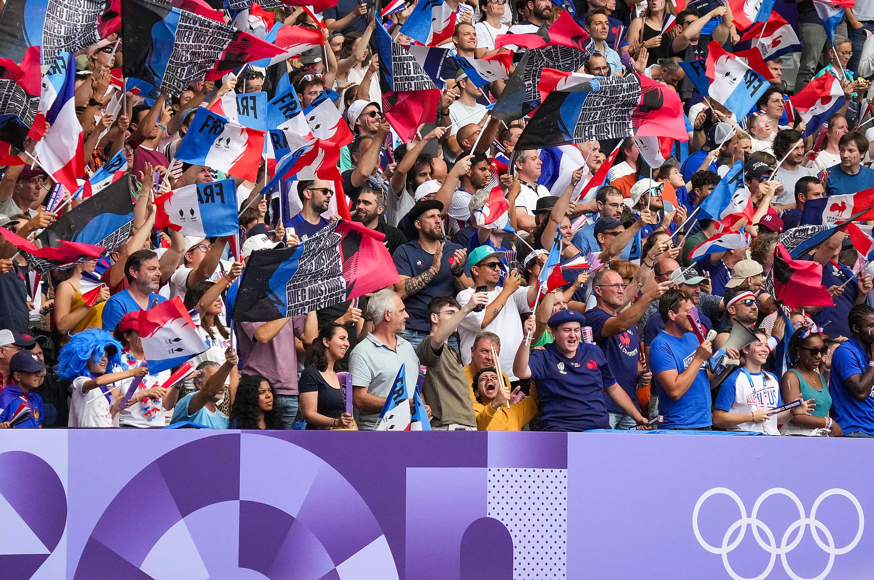 Fans celebrate a try by France forward Rayan Rebbadj during a men’s rugby sevens pool match...