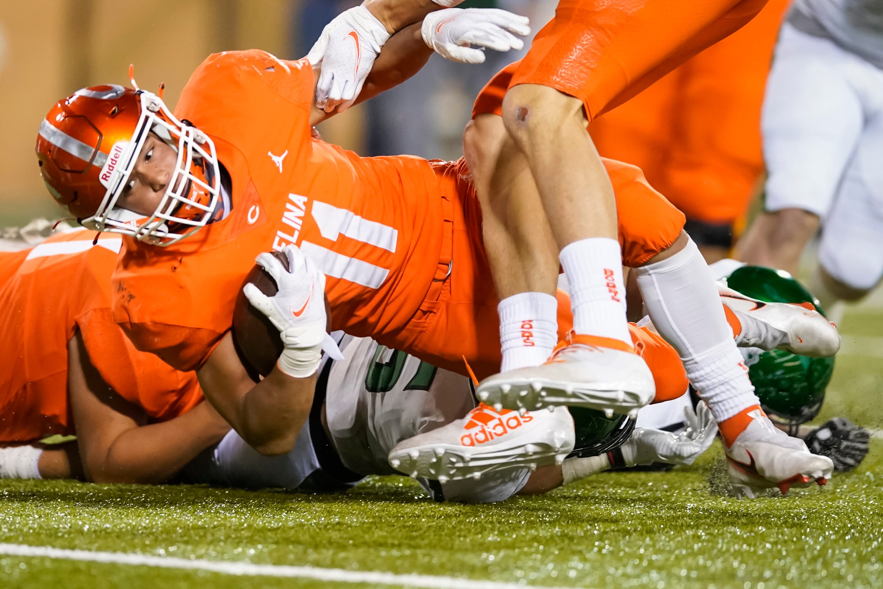 Celina running back  Gabe Gayton (11) is brought down by Iowa Park defensive back Connor...