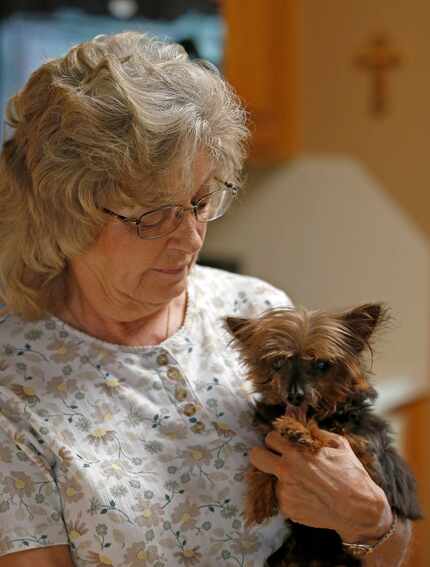 Jackie Merrell holds her 15-year-old dog at her home in Cedar Hill. Tammy Miller, manager of...