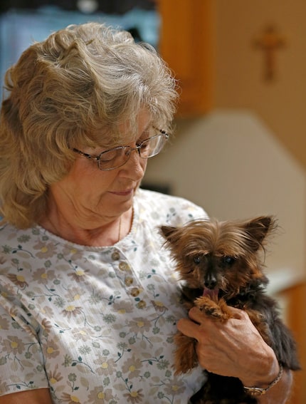 Jackie Merrell holds her 15-year-old dog at her home in Cedar Hill. Tammy Miller, manager of...