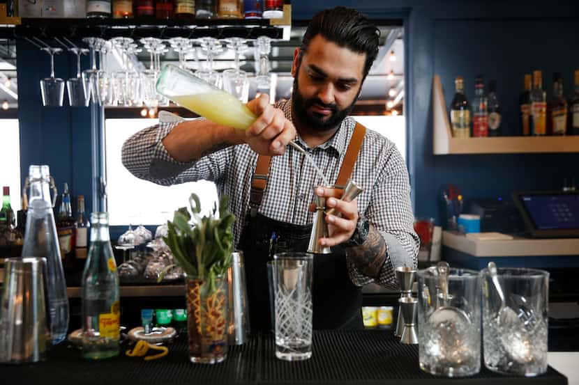 Former RM 12:20 bartender Ravinder Singh mixes a sparkling rosemary and sage mocktail....