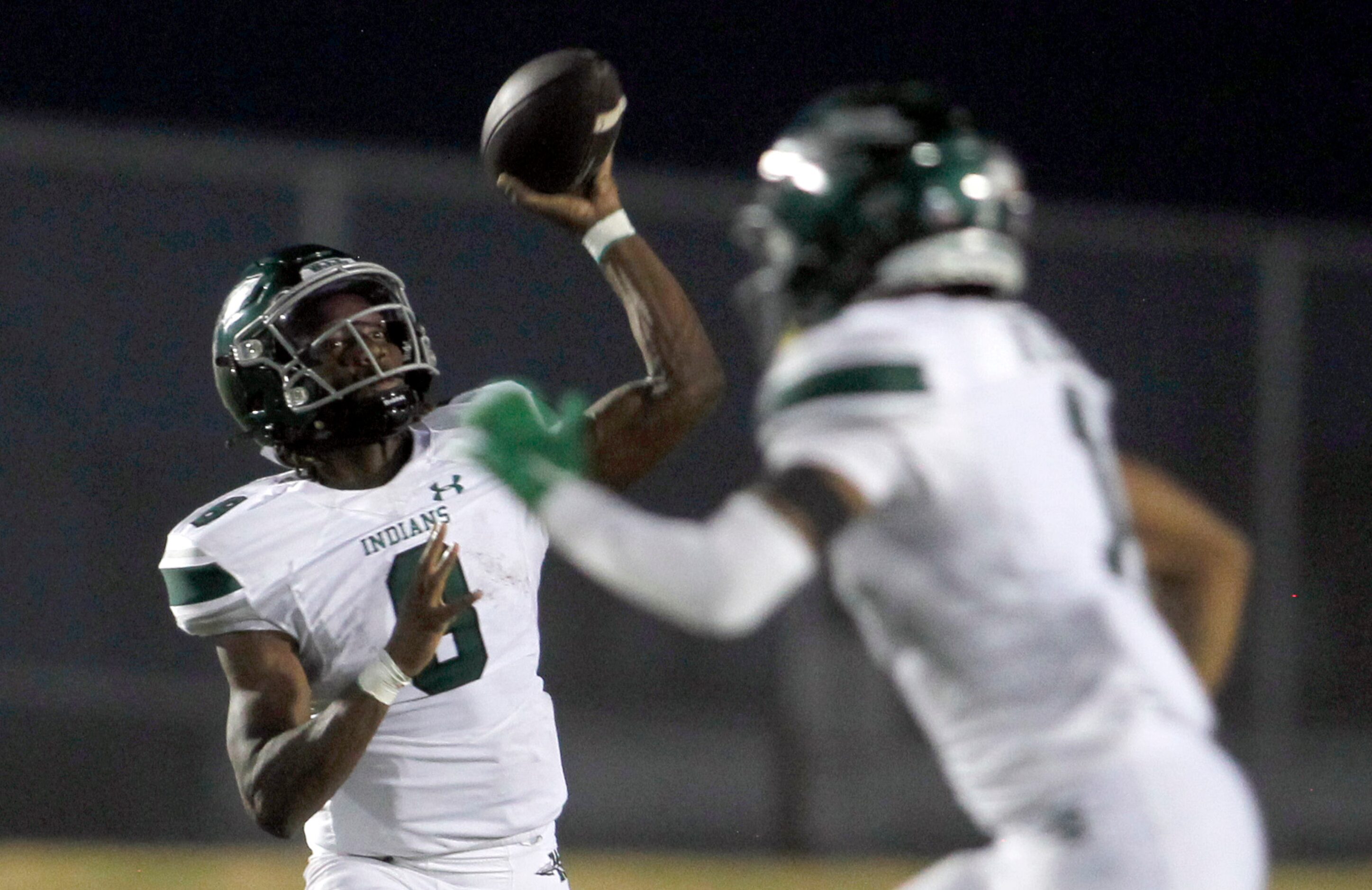 Waxahachie quarterback Ramon McKinney Jr. (8) launches a pass during first half action...