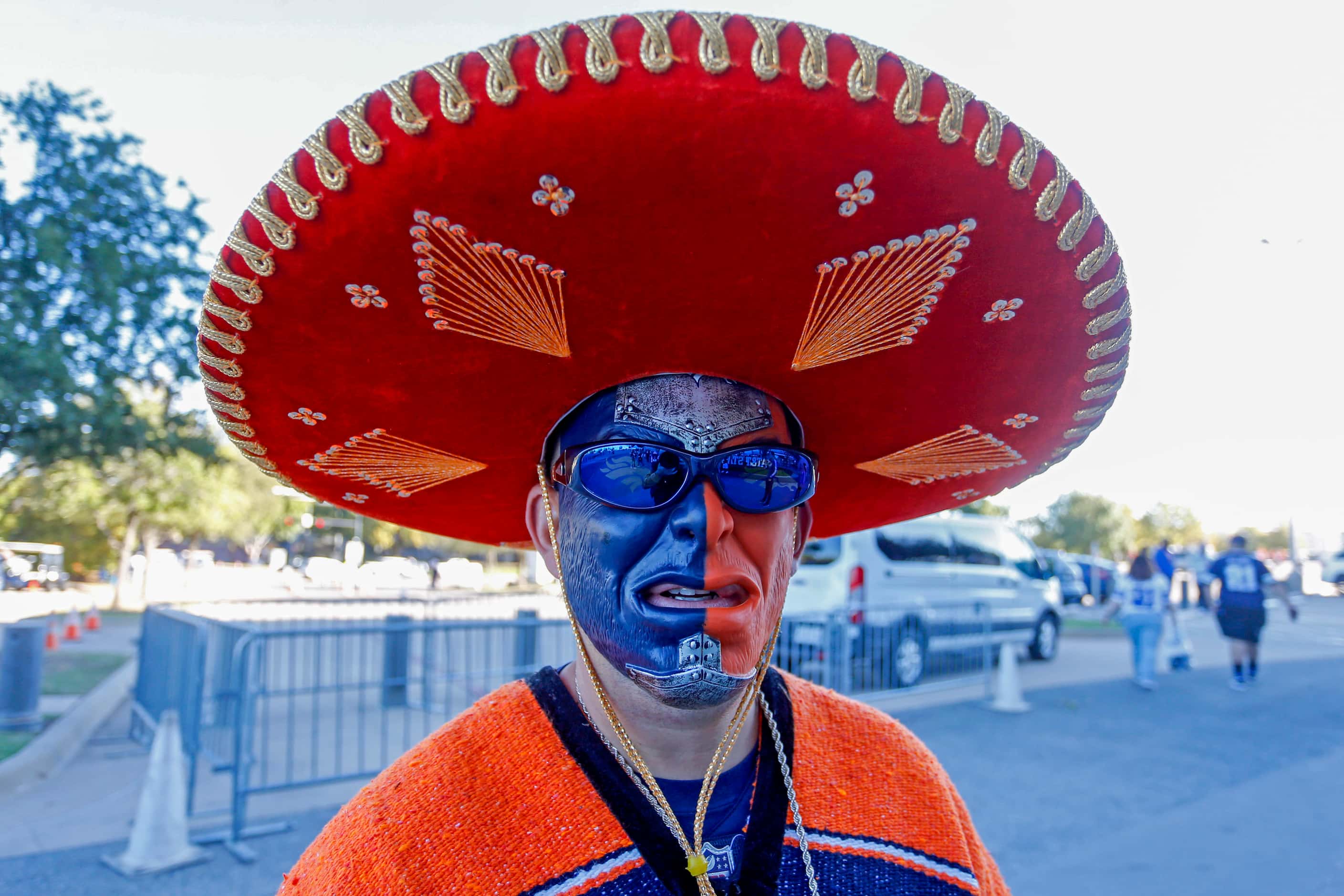 Denver Broncos fan Larry Saiz, of Pocatello, ID, sports a mask and bright orange outfit on...