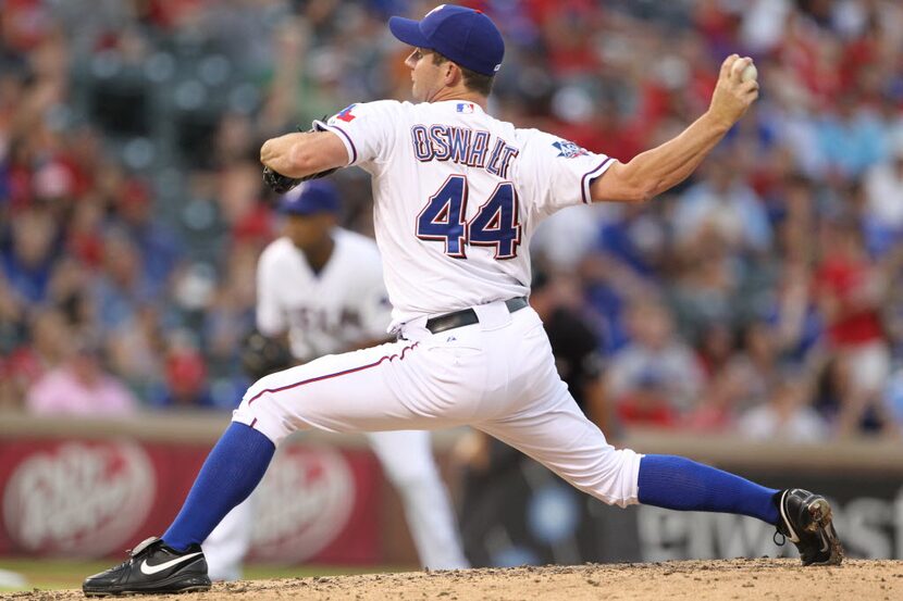 Texas starting pitcher Roy Oswalt throws a second-inning pitch during the Minnesota Twins...