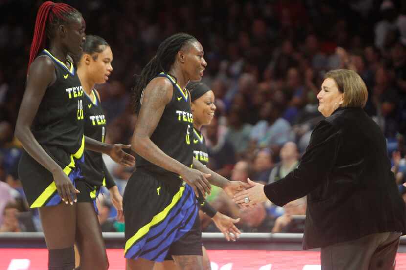 Dallas Wings head coach Latricia Trammell, right, welcomes Natasha Howard (6), center, and...