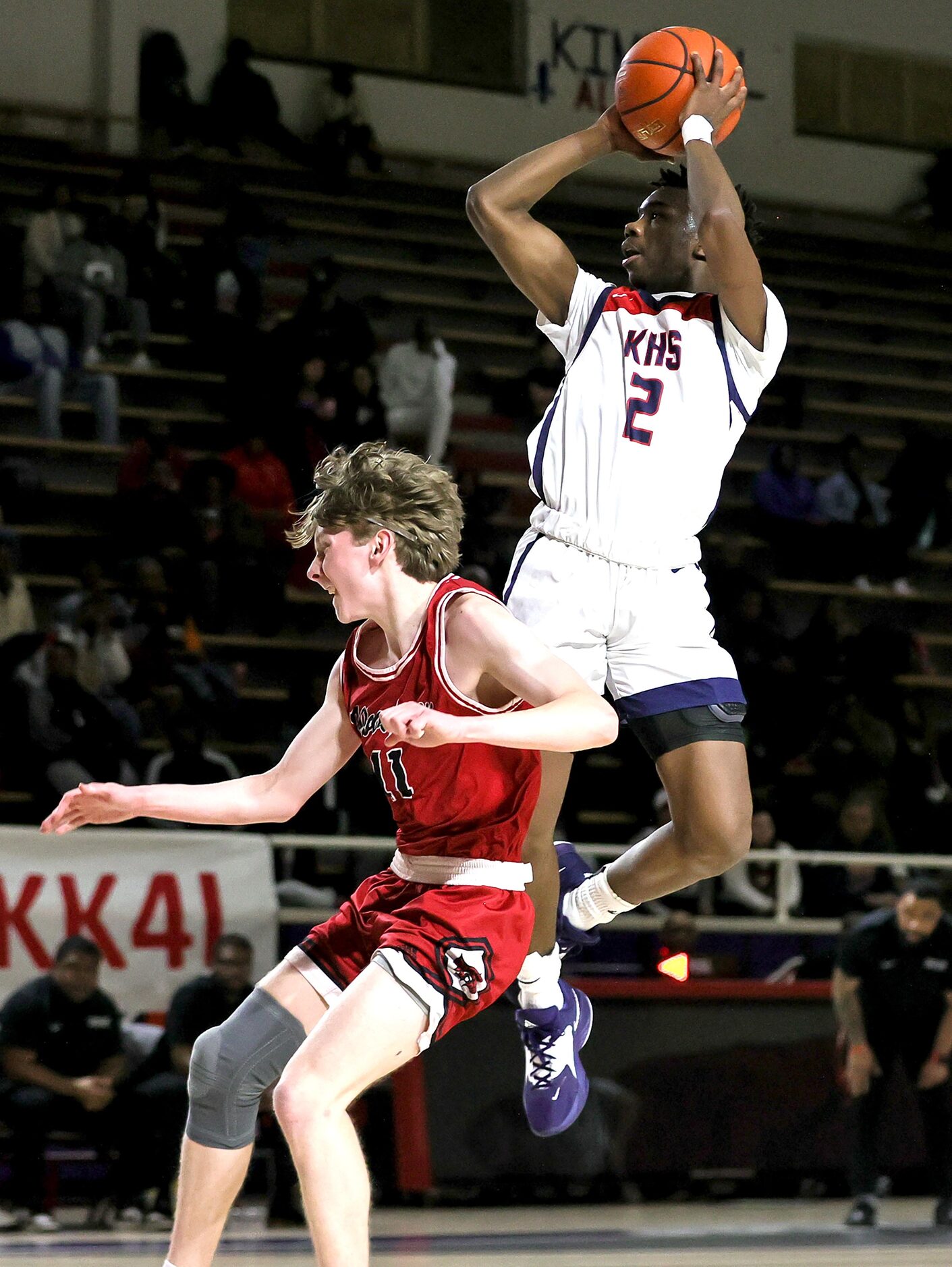 Kimball guard T'Johnn Brown (2) tries to get off a shot against Woodrow Wilson guard Brian...