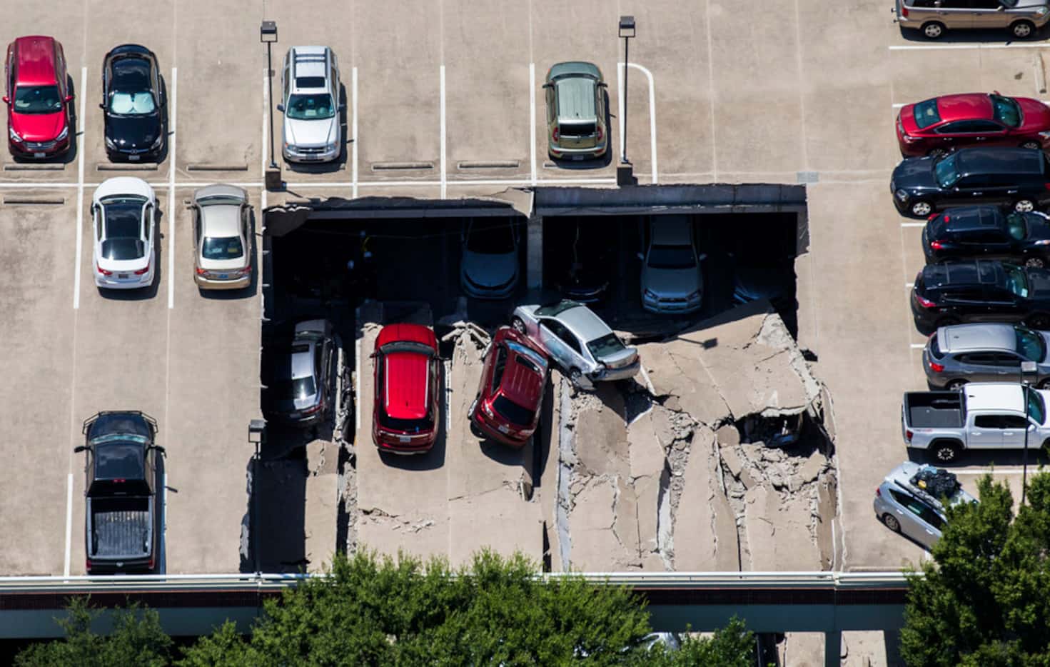 Two sections of an Irving, Texas, parking garage collapsed Tuesday. The first section...