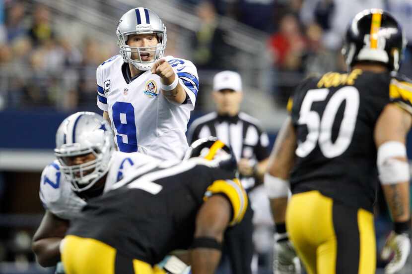 Dallas Cowboys quarterback Tony Romo (9) directs traffic at the line of scrimmage against...