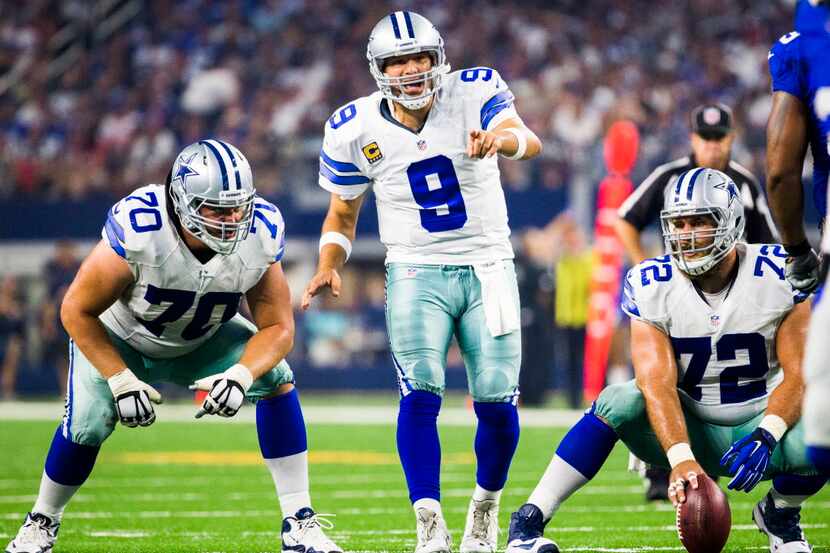 Dallas Cowboys quarterback Tony Romo (9) shouts instructions to his team at the line of...