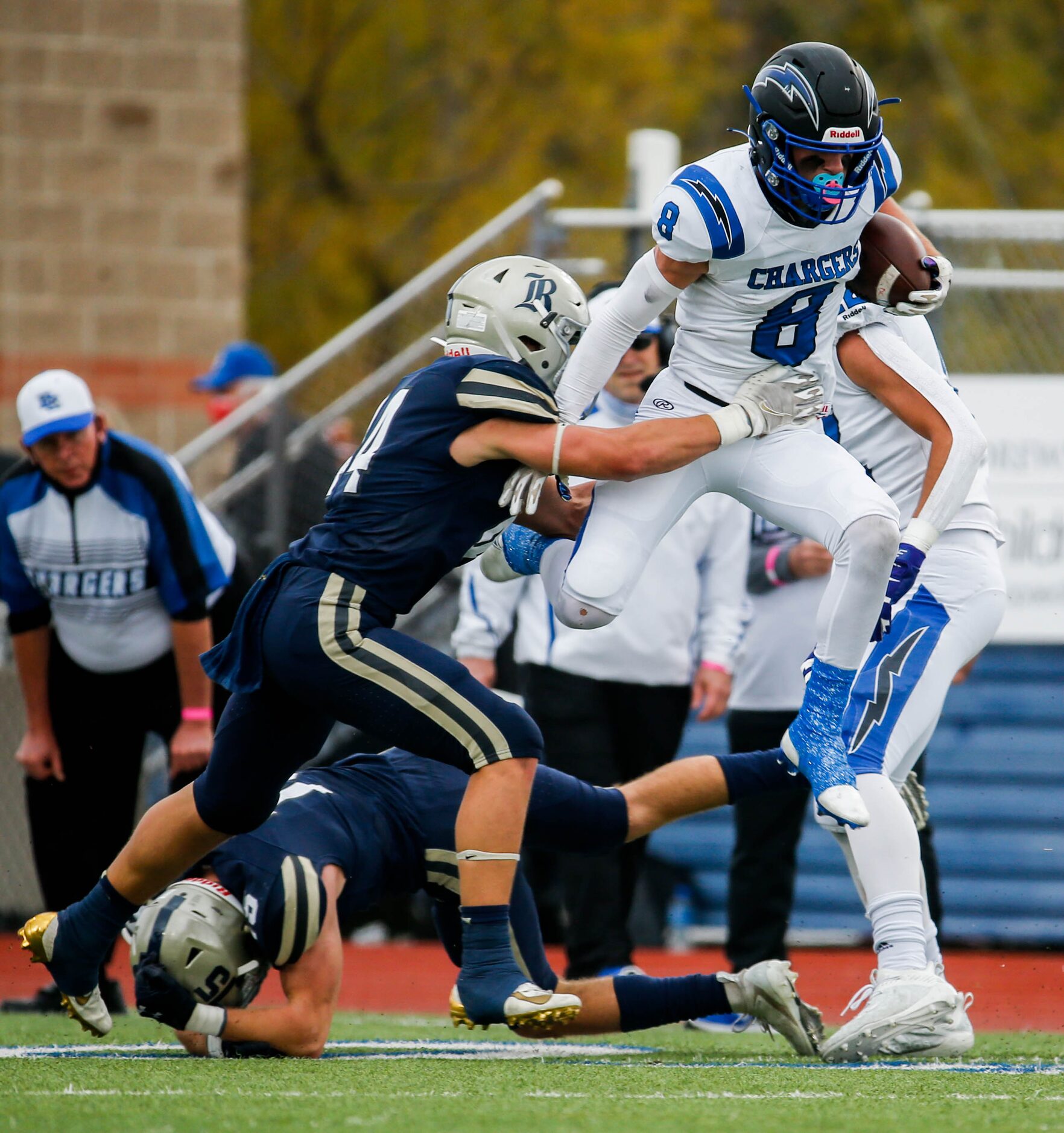 Dallas Christian's Parker Robertson (8) jumps over Austin Regents' Benedict Buerkle (15)...