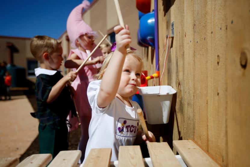 Hadley Herron, 2, plays an instrument at the new Wizard of Oz space at Celina Elementary....