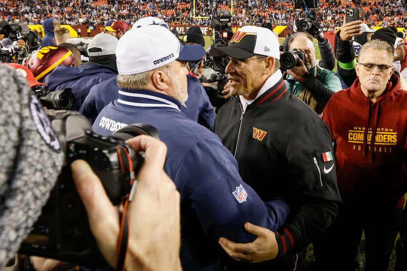Dallas Cowboys head coach Mike McCarthy talks with Washington Commanders head coach Ron...